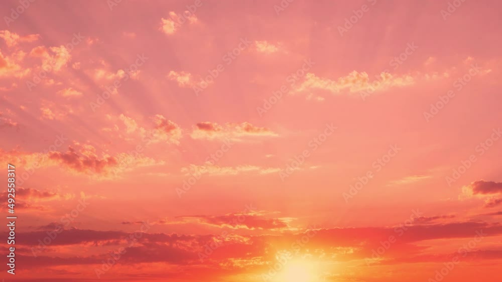 Beautiful Red Pink Coral Sky in Rays of Sun at Sunset, Sun Sets Over Horizon in Field Filling Light with Valley Sky and Light Cirrus Clouds, Time Lapse, Slow Motion.