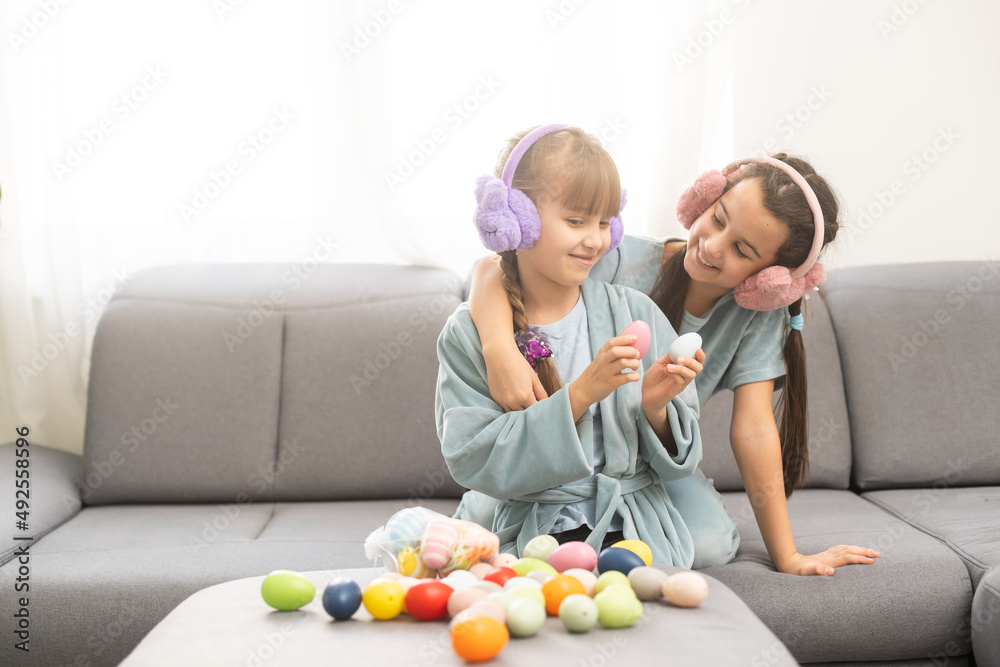 Funny little girls with Easter eggs Funny little girls with Easter eggs