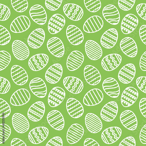 Easter seamless pattern of white eggs on green background. Hand drawn eggs with stripes, waves and zigzags. Spring holiday background. Vector Illustration