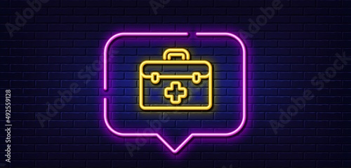 Neon light speech bubble. First aid line icon. Medicical kit sign. Pharmacy medication symbol. Neon light background. First aid glow line. Brick wall banner. Vector