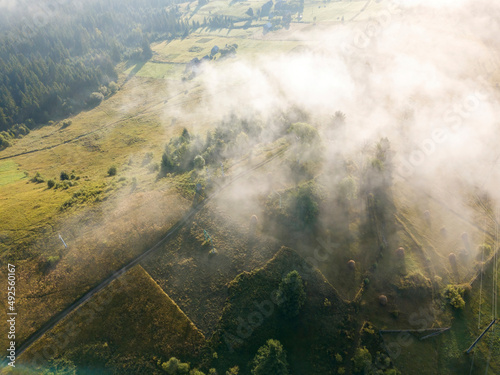 Green mountains of the Ukrainian Carpathians in the morning mist. Aerial drone view.