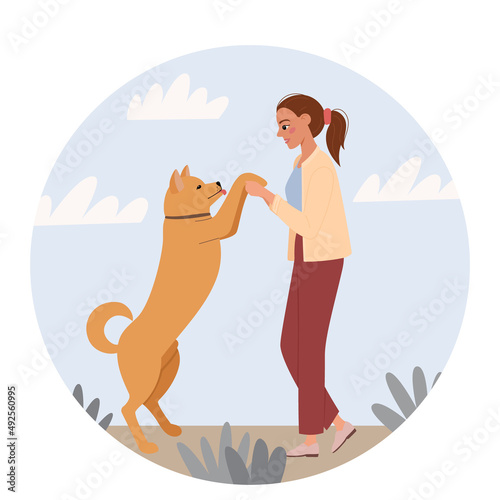 Young woman is playing with pet. The dog is standing on its hind legs. Cute illustration of the relationship and friendship between human and animal. Vector in flat cartoon style.