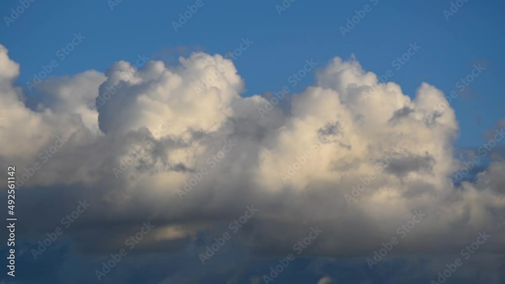 Time lapse with white cumulus cloud moving across blue sky Time lapse with white cumulus cloud moving across blue sky
