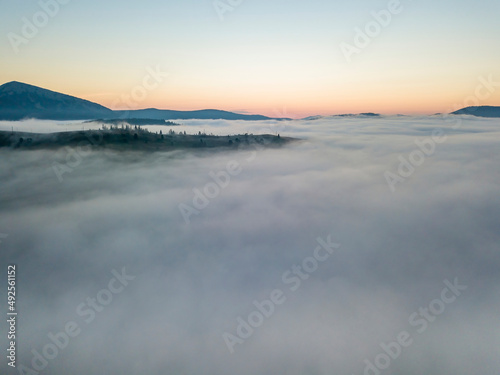 Morning fog in the Ukrainian Carpathians. Aerial drone view. © Sergey