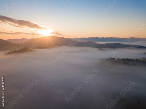 Sunrise over the fog in the Ukrainian Carpathians. Aerial drone view.