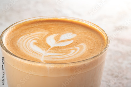 Coffee foam on a cappuccino or latte glass close-up with a drawing. Beautiful drawing on coffee foam
