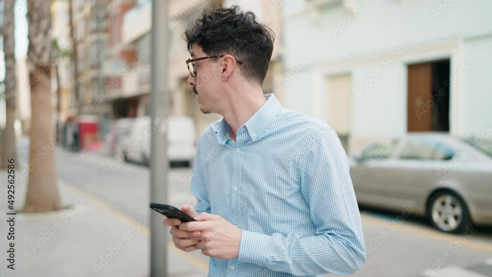 Young hispanic man smiling confident using smartphone at street Young hispanic man smiling confident using smartphone at street