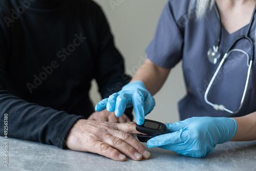 Elderly people measuring their pulse with their fingertips at a long-term care facility