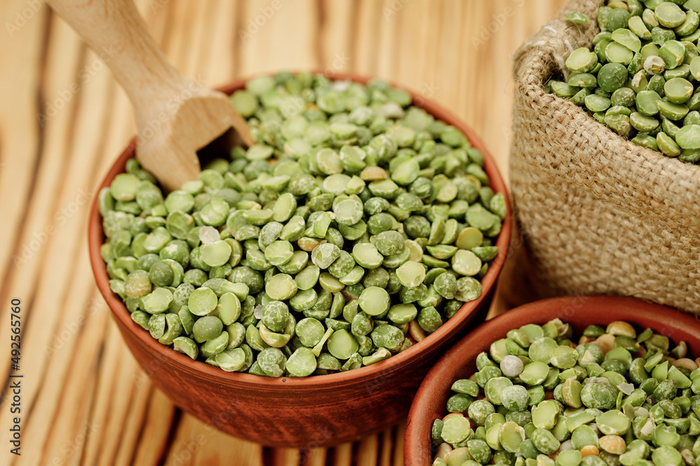 Green pea groats in bowls and bags on a wooden background. High quality photo Green pea groats in bowls and bags on a wooden background. High quality photo
