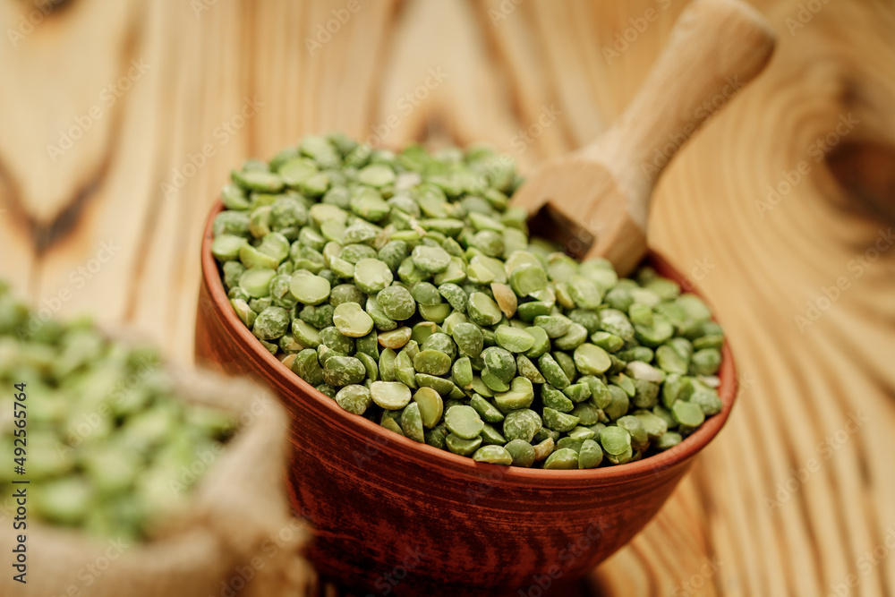 Green pea groats in bowls and bags on a wooden background. High quality photo Green pea groats in bowls and bags on a wooden background. High quality photo