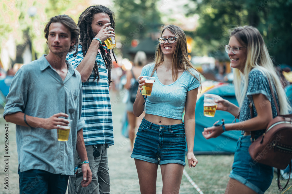 Friends drinking beer and having fun at music festival Friends drinking beer and having fun at music festival