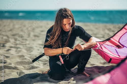 Woman using flying lines and a control bar for kitesurfing photo