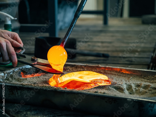 Melting glass mould into sand form photo