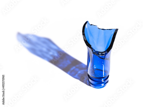 Canvas Print Broken blue bottle which is made of glass on white background, Recycle image, No