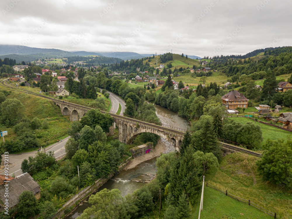 Old railway bridge in the mountains. Ukrainian Carpathians. Aerial drone view.