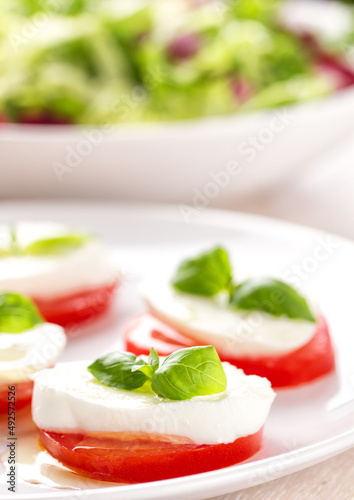 Caprese Salad with tomatoes, basil, mozzarella, olive oil. Mediterranean, organic and natural food concept