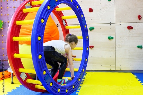 Obraz na plátne an autistic girl passes in a squirrel wheel with a ladder treatment in at the do