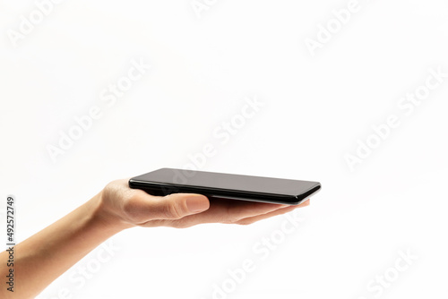 woman holding phone in hand on white background
