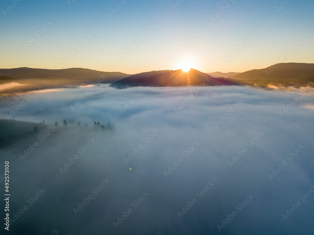 Sunrise over the fog in the Ukrainian Carpathians. Aerial drone view.