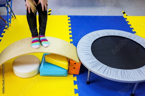 an autistic girl is treated in the form of a game by a psychologist, exercises on the ballancer help the brain, balance
