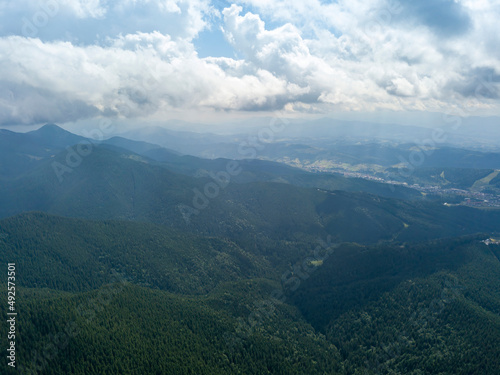 Green mountains of Ukrainian Carpathians in summer. Sunny day, rare clouds. Aerial drone view. © Sergey