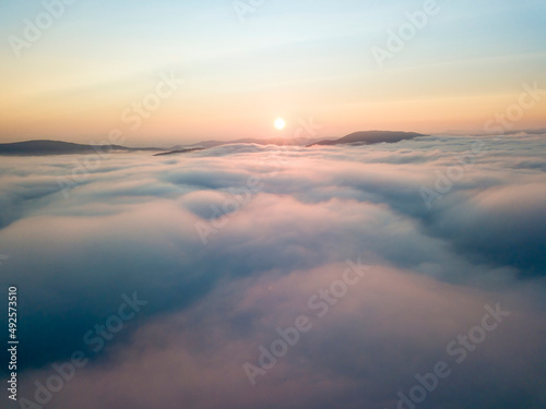Fototapeta Naklejka Na Ścianę i Meble -  Sunrise over the fog in the Ukrainian Carpathians. Aerial drone view.
