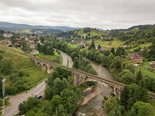 Old railway bridge in the mountains. Ukrainian Carpathians. Aerial drone view.