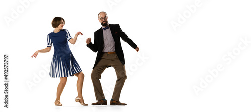 Flyer. Couple of dancers, young man and woman in vintage retro style outfits dancing swing dance isolated on white background. Timeless traditions, 60s, 70s fashion style.