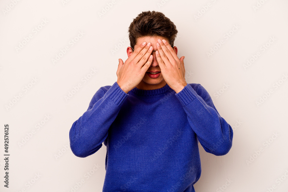 Young caucasian man isolated on white background afraid covering eyes with hands. Young caucasian man isolated on white background afraid covering eyes with hands.