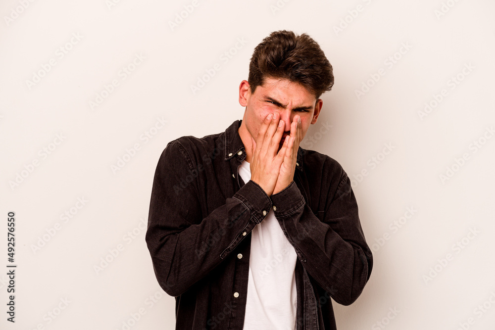 Young caucasian man isolated on white background laughing about something, covering mouth with hands. Young caucasian man isolated on white background laughing about something, covering mouth with hands.