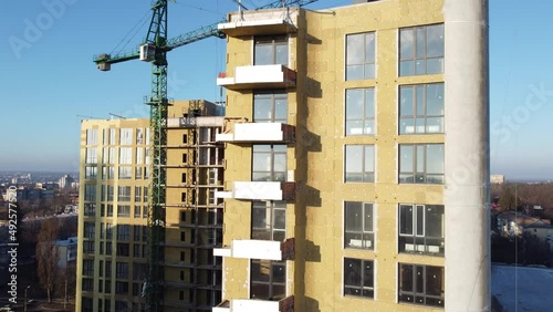Building external wall thermal insulation with mineral wool. Exterior passive house wall heat insulation with mineral wool. Insulation the facade of commercial building. Energy efficiency