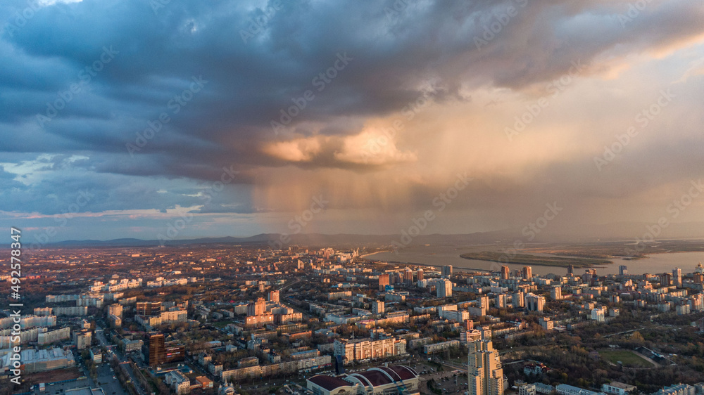 Fototapeta premium Khabarovsk city top view sunset beautiful clouds in the rain