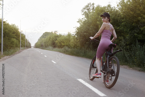 The girl cyclist is engaged in sports, the concept of a healthy lifestyle