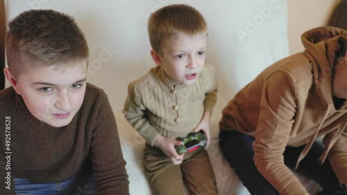 children playing on the console with joysticks in ruhs close-up photo