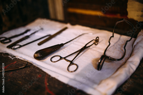 Surgical instruments for medical operation on a wooden table.