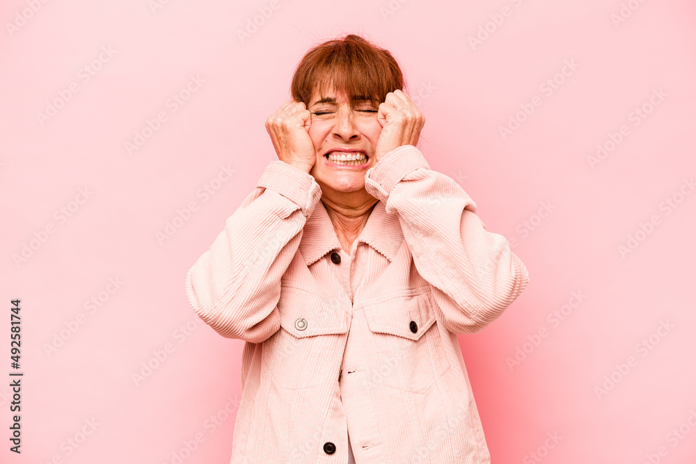Middle age caucasian woman isolated on pink background crying, unhappy with something, agony and confusion concept. Middle age caucasian woman isolated on pink background crying, unhappy with something, agony and confusion concept.