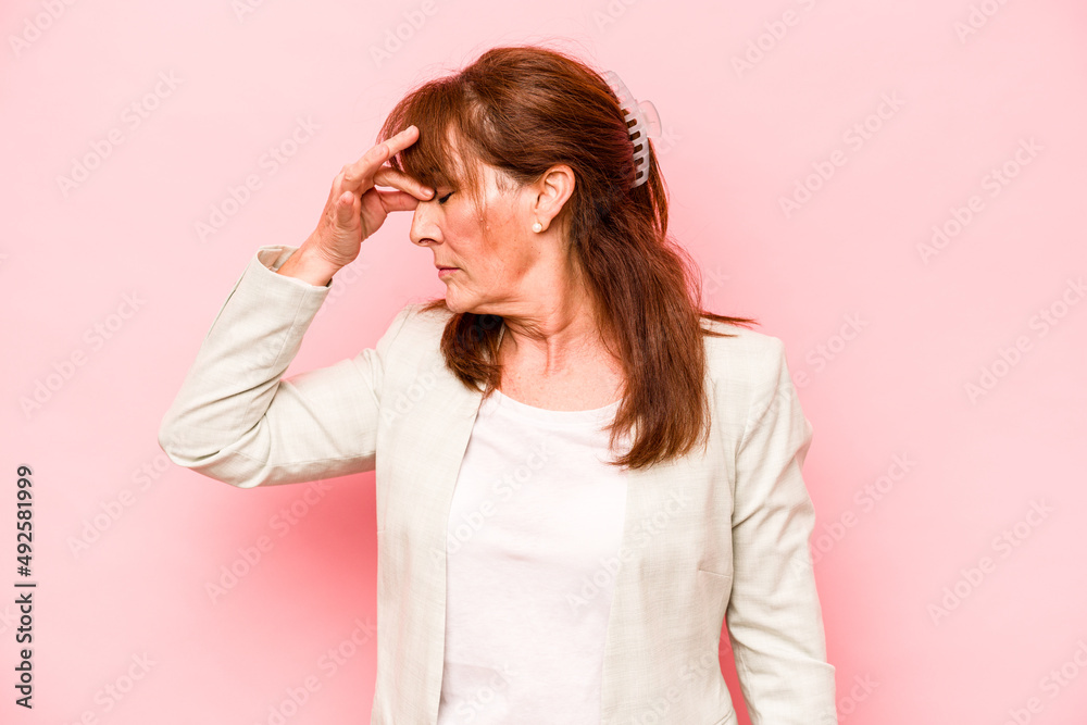 Middle age caucasian woman isolated on pink background having a head ache, touching front of the face. Middle age caucasian woman isolated on pink background having a head ache, touching front of the face.