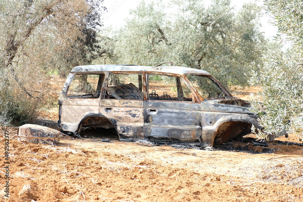 Burnt out and abandoned car in the field Burnt out and abandoned car in the field