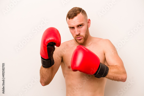 Young caucasian man doing boxing isolated on white background © Asier