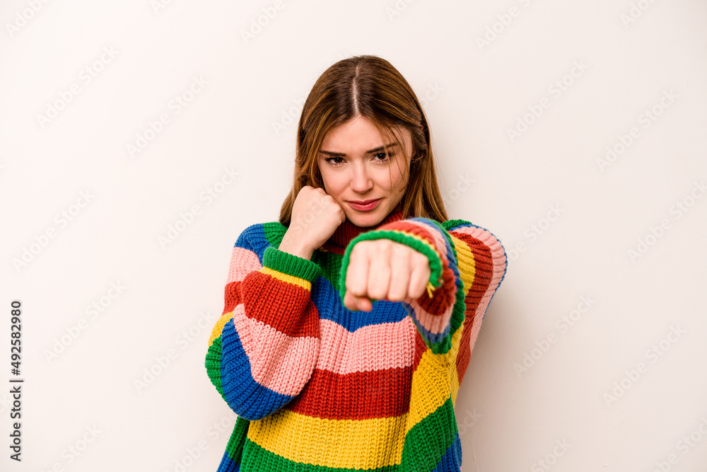 Young caucasian woman isolated on white background throwing a punch, anger, fighting due to an argument, boxing. Young caucasian woman isolated on white background throwing a punch, anger, fighting due to an argument, boxing.