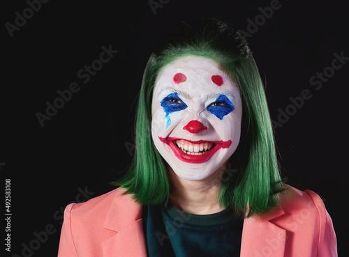Photo shoot in the Studio on a dark background, the image of a terrible clown