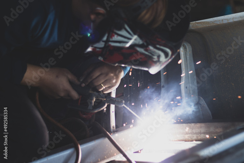 welder, welding automotive part in a car factory