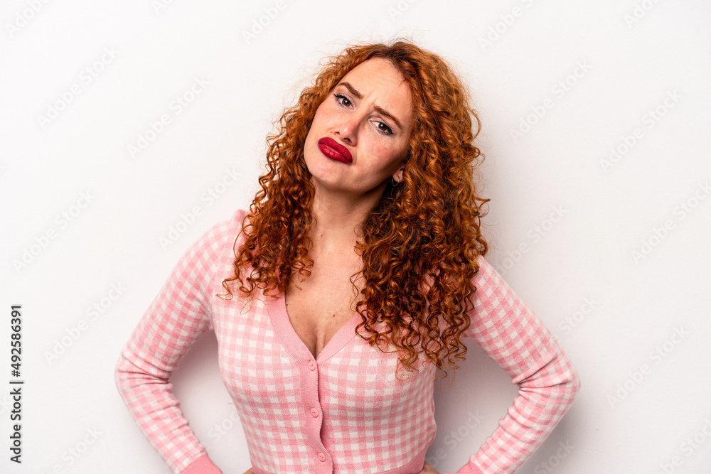 Young ginger caucasian woman isolated on white background sad, serious face, feeling miserable and displeased.