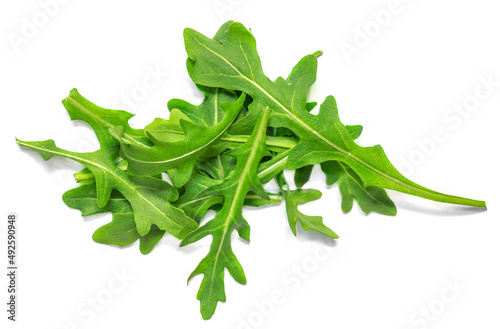 Fresh green arugula leaves isolated on white background, top view, flat lay. Pile of ruccola photo