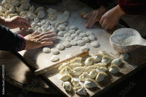 Making traditional dim sum Chinese dumplings. Meat dough pastry and spring onions cuisine. Farm kitchen Shandong Province, China