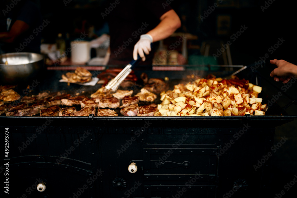 street food potato with meat and chef's hand street food potato with meat and chef's hand