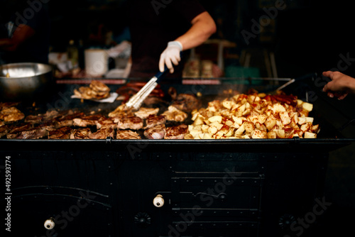 street food potato with meat and chef's hand