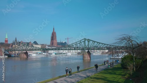 Eiserner Steg of Frankfurt am Main Bridge over the river Main with people on a sunny day photo