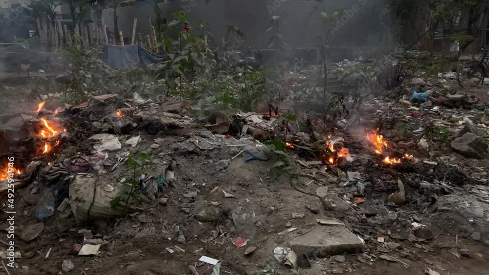 Burning of stubble waste in the streets of the city of Dhaka, Bangladesh Burning of stubble waste in the streets of the city of Dhaka, Bangladesh