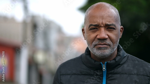 A senior black man portrait face with serious expression looking at camera photo